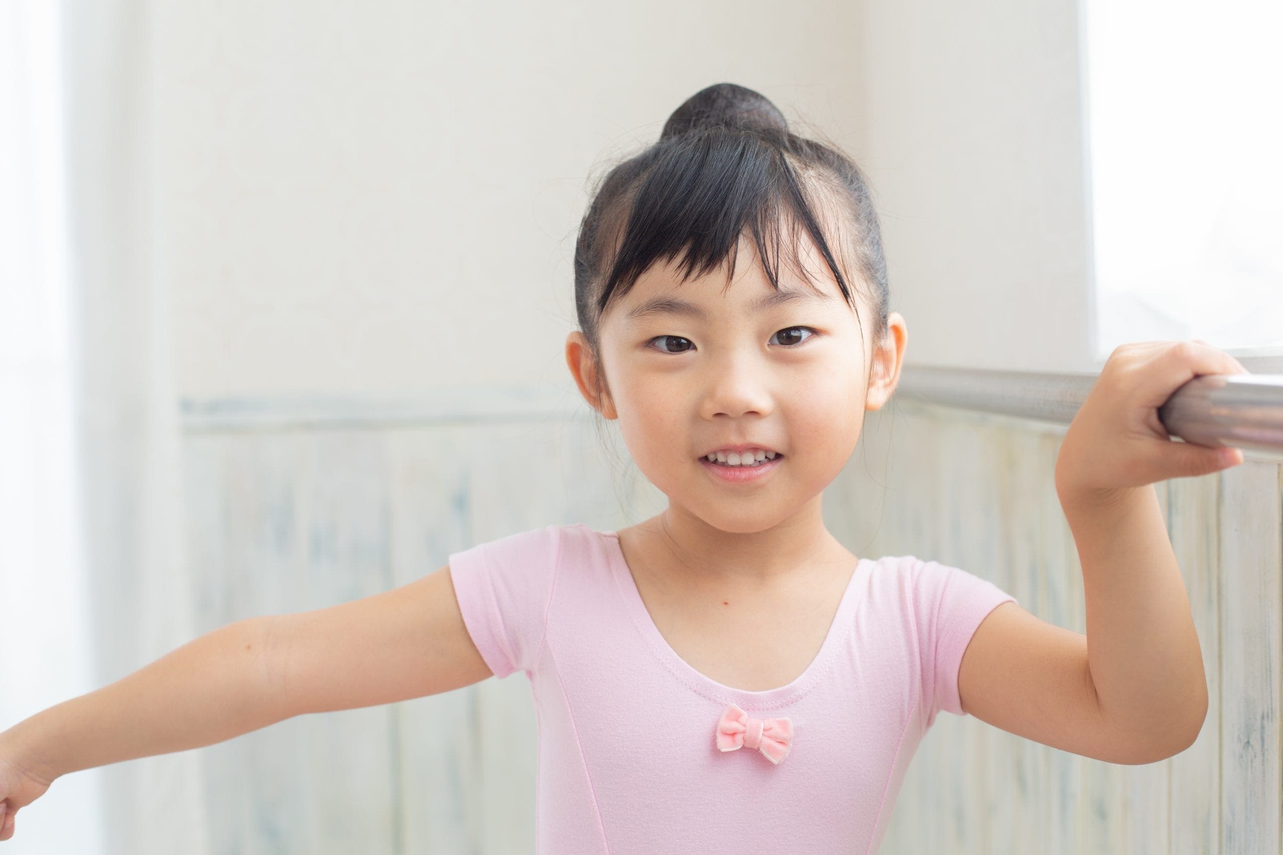 Smiling Dancer at barre in pink